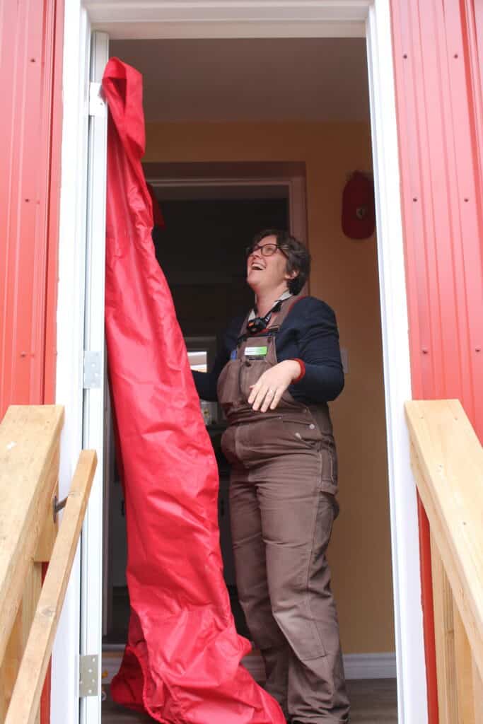 A Registered Energy Advisor conducting a blower door test