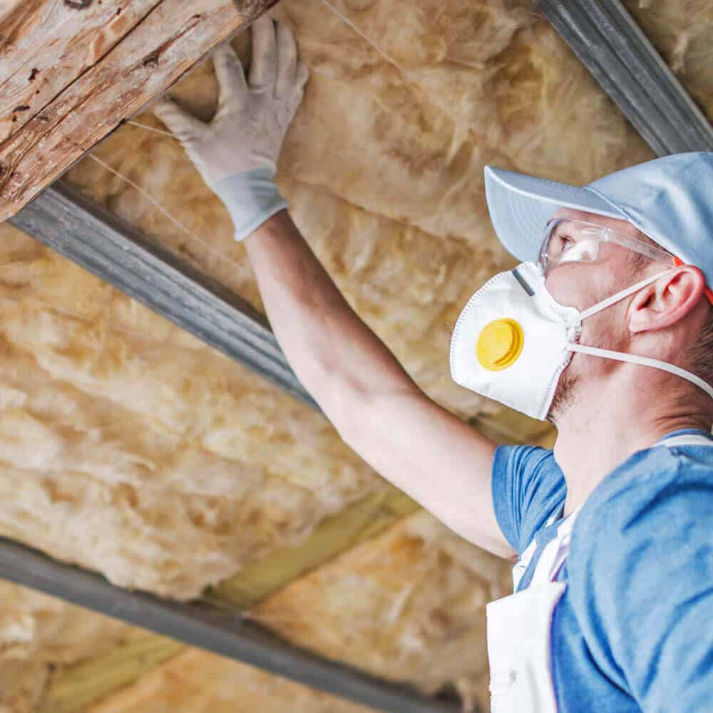 Contractor checking attic insulation
