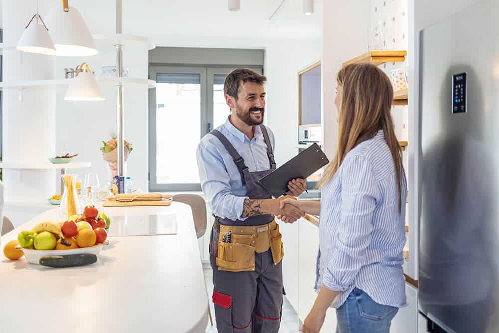 Contractor shaking the hand of a homeowner in a kitchen